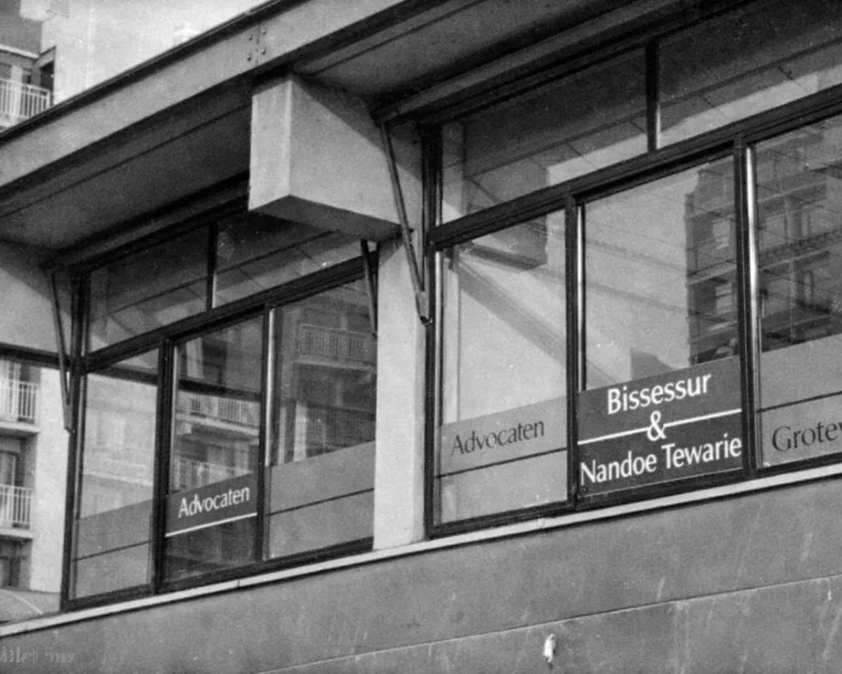 Historic photo of an early Bissessur law office, with "Advocaten" on the windows